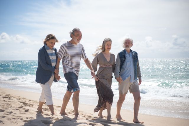 elderly couples walking on the beach